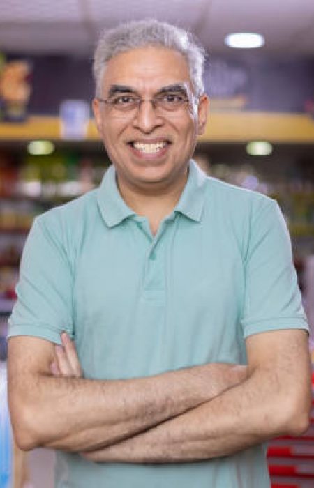 Happy senior man at supermarket store